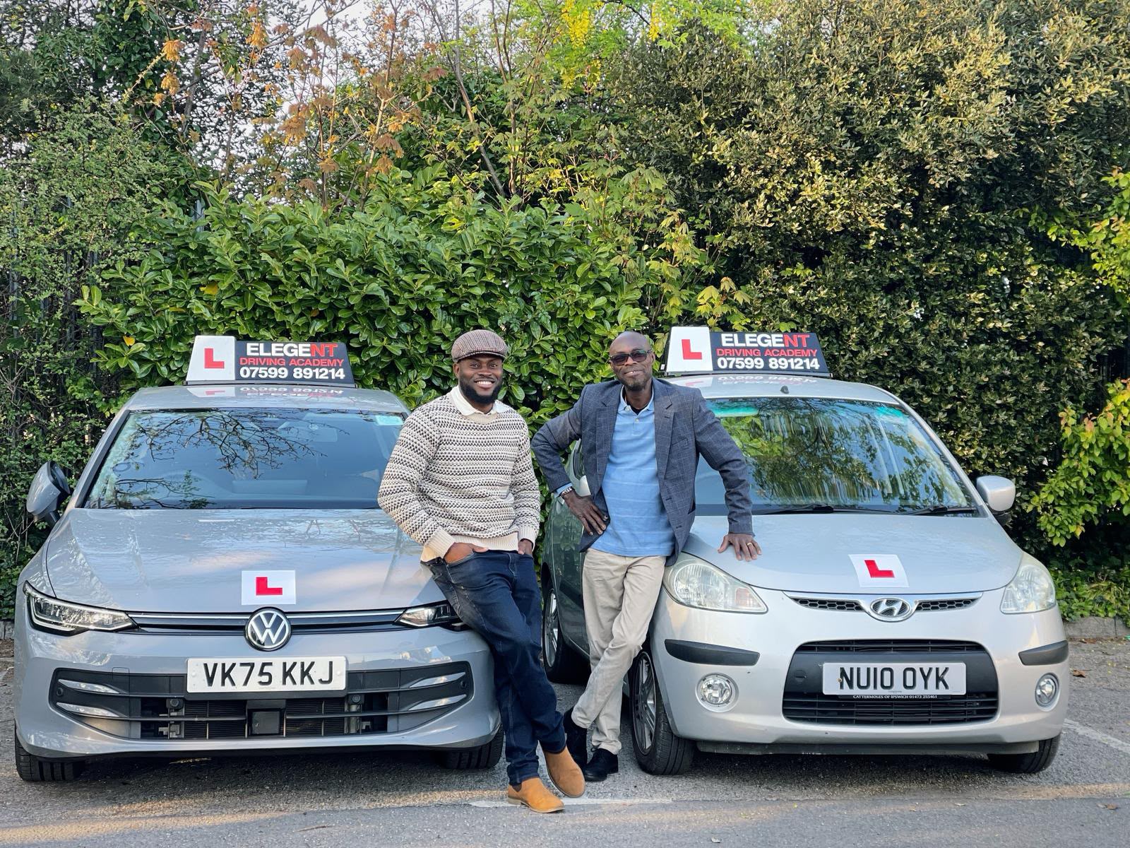Elegent Driving Academy instructors standing by academy vehicles